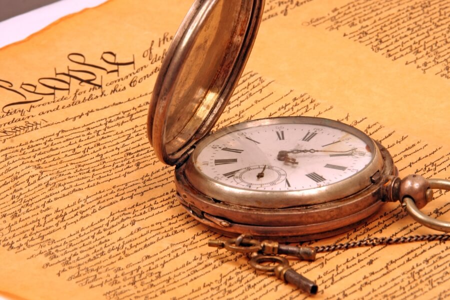 pocket watch on top of a book