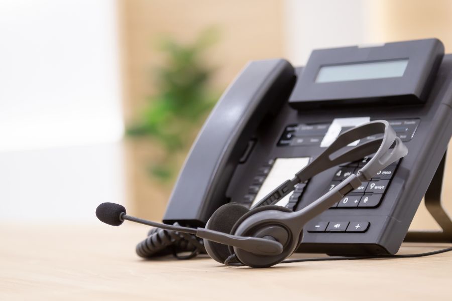 black telephone and headset on table