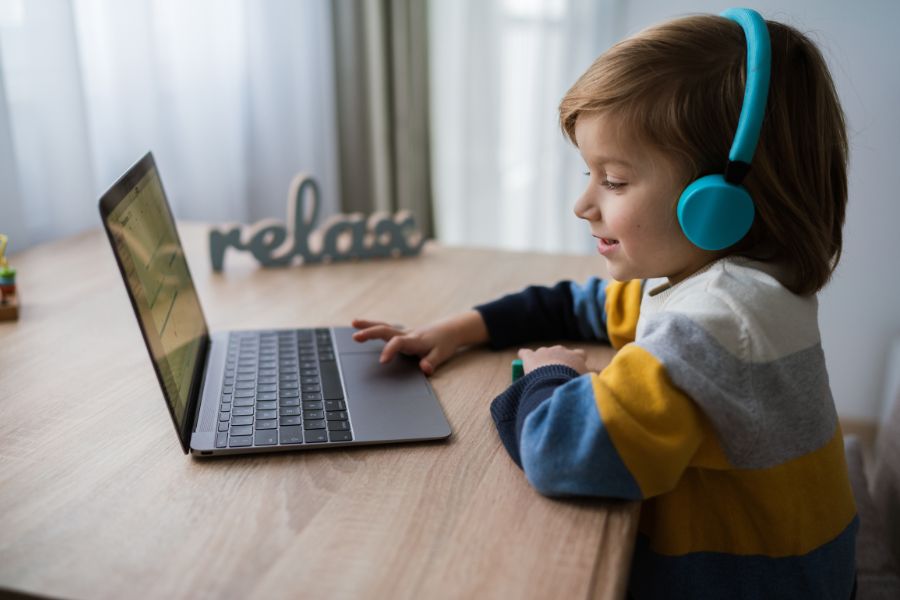 little child using laptop at home