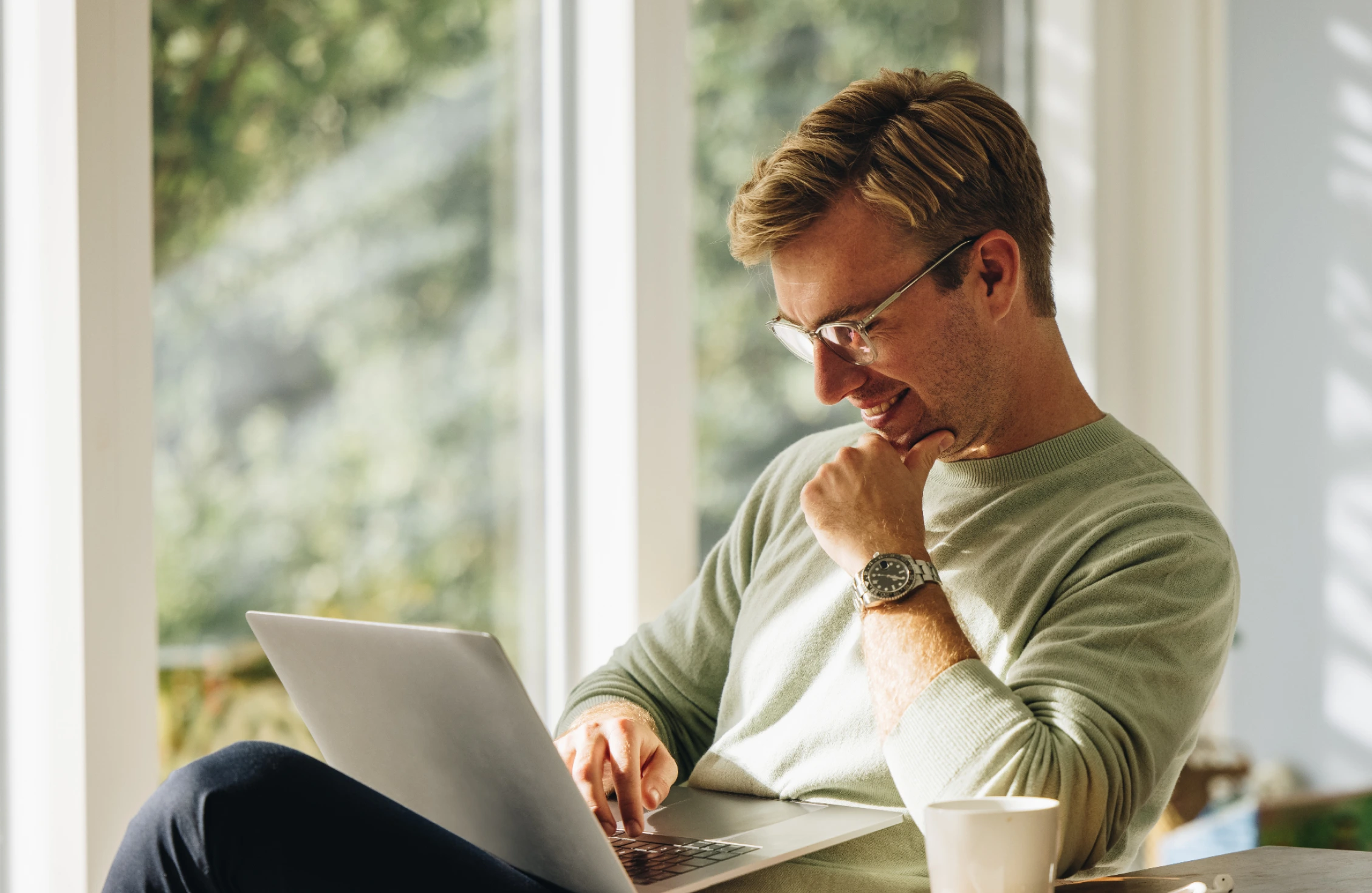 A happy man using a laptop