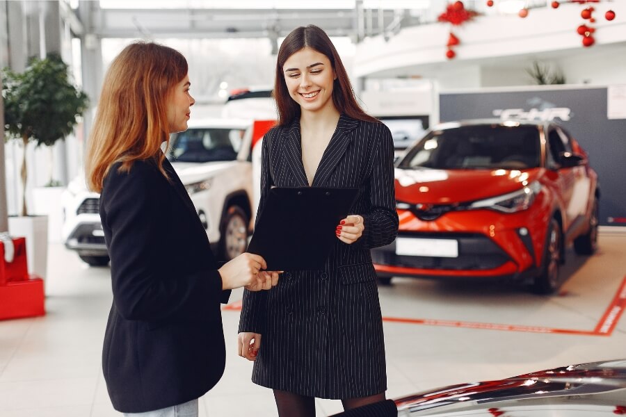 car sales agent assisting a client